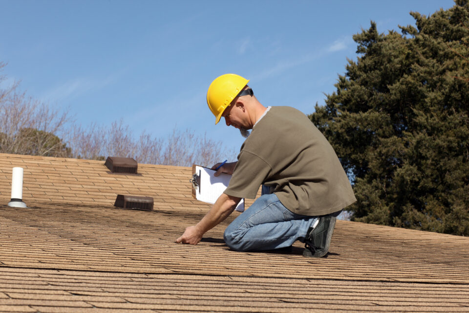 Home inspector checking the roof of a house