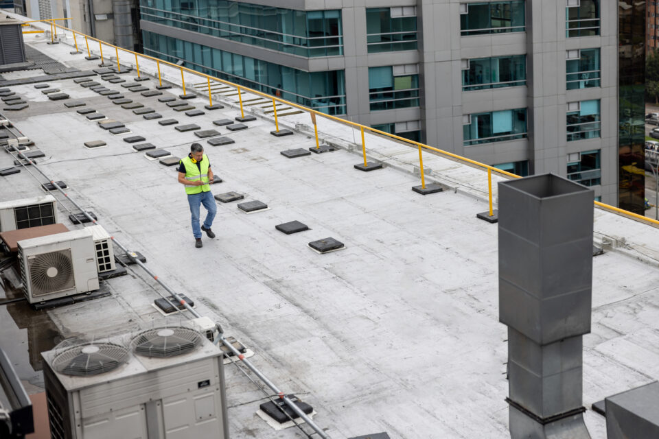 Maintenance engineer doing a routine inspection on the rooftop of a building